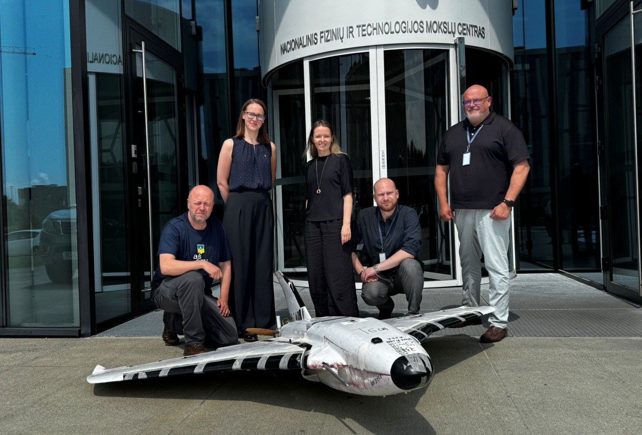Group photo of FTMC and Blue/Yellow representatives with the drone outdoors. FTMC photo.